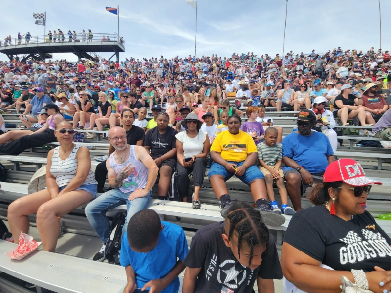 A group of people sitting inside a stadium