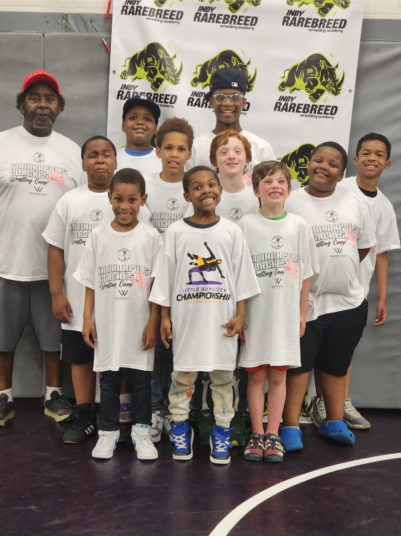 A group of young wrestlers with their coach