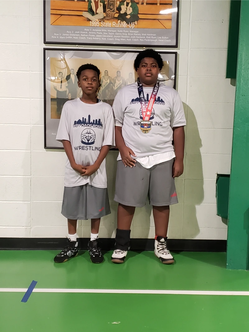 Two young wrestling academy students posing for a photo